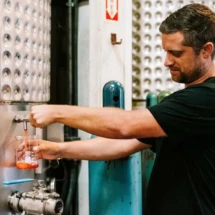 Winemaker Justin Knight trying a sample of a wine that is sitting in production to see if the quality is to his liking